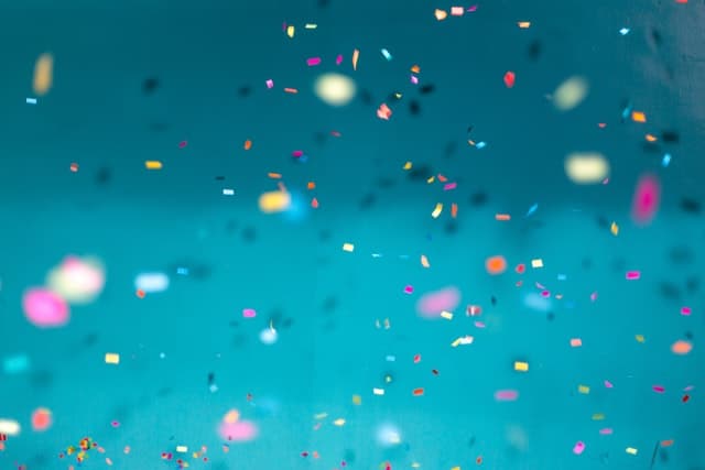 Colourful confetti on a teal background